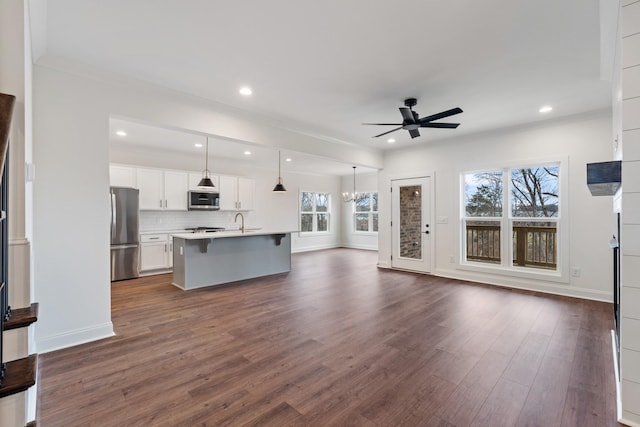 kitchen featuring pendant lighting, dark hardwood / wood-style flooring, a healthy amount of sunlight, and appliances with stainless steel finishes