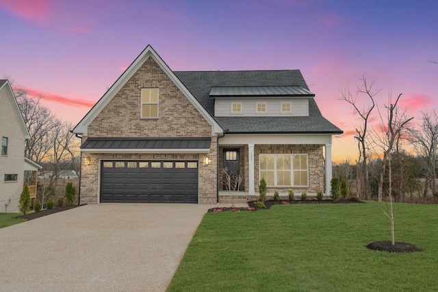 view of front of property featuring a lawn and a garage