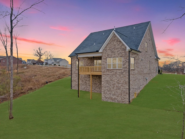 outdoor structure at dusk featuring a yard