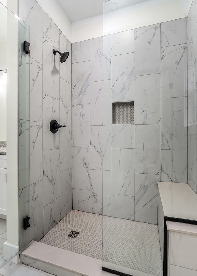 bathroom with a tile shower