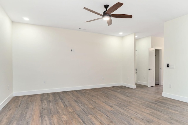 unfurnished room with ceiling fan and dark hardwood / wood-style floors