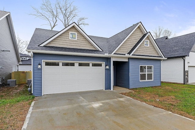 view of front of house featuring cooling unit and a garage