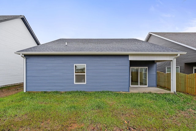 back of property with a patio area and a yard