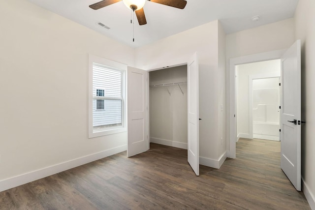 unfurnished bedroom featuring a closet, dark hardwood / wood-style floors, and ceiling fan