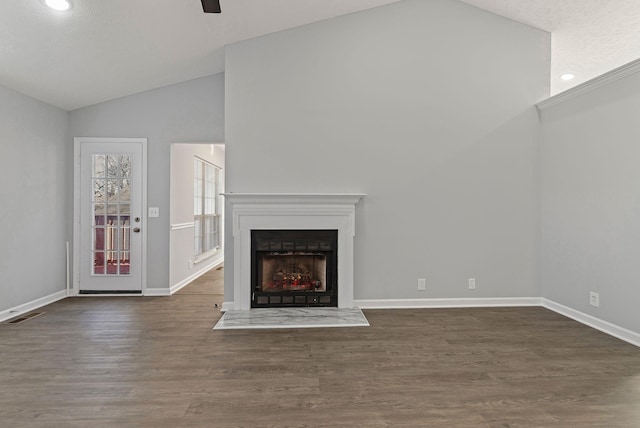 unfurnished living room featuring high vaulted ceiling, dark wood-type flooring, and a textured ceiling