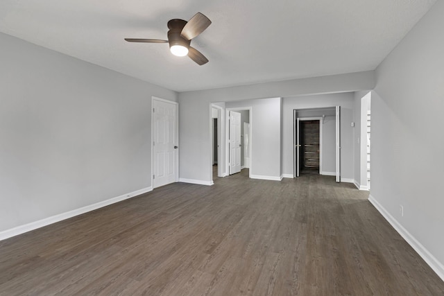 spare room with dark hardwood / wood-style flooring and ceiling fan