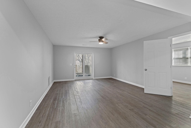 spare room featuring ceiling fan and dark wood-type flooring