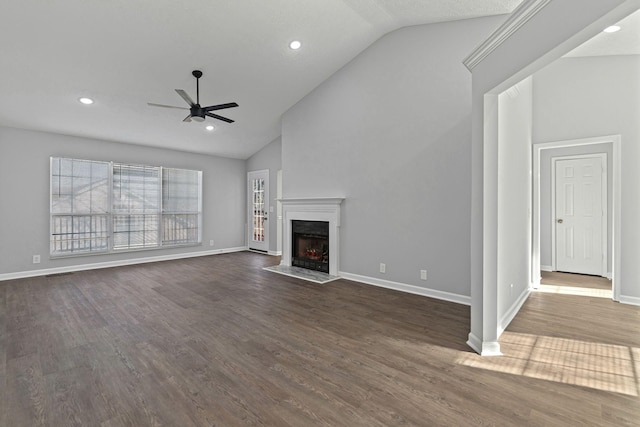 unfurnished living room with dark hardwood / wood-style floors, high vaulted ceiling, and ceiling fan