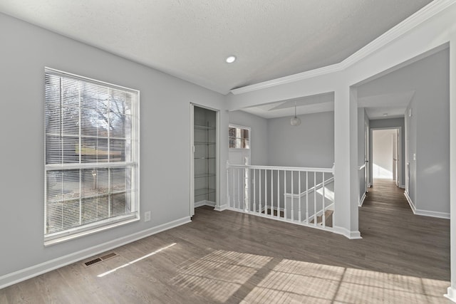 unfurnished room with dark hardwood / wood-style flooring and a healthy amount of sunlight