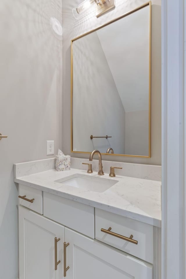 bathroom featuring vanity and vaulted ceiling