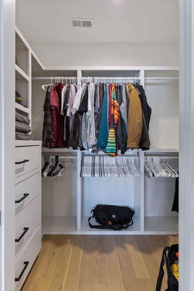 spacious closet featuring light hardwood / wood-style floors