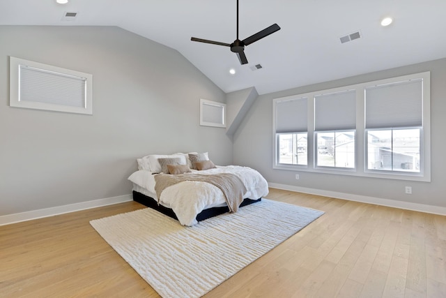 bedroom featuring multiple windows, light wood-type flooring, ceiling fan, and lofted ceiling