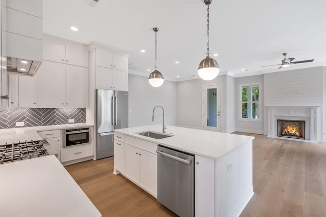 7085 Bolton St, Franklin, TN 37064 - kitchen featuring stainless steel appliances, tasteful backsplash, light countertops, white cabinets, and hanging light fixtures