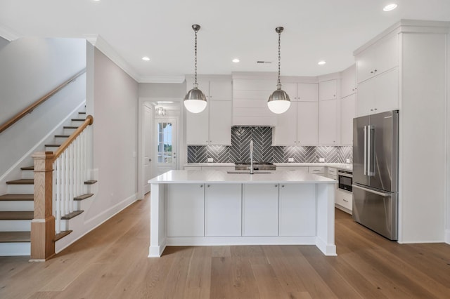 7085 Bolton St, Franklin, TN 37064 - kitchen featuring high end refrigerator, light countertops, backsplash, white cabinets, and ornamental molding