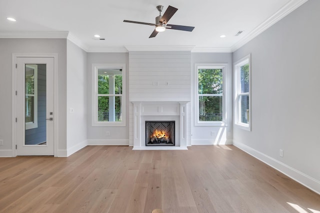 7085 Bolton St, Franklin, TN 37064 - unfurnished living room featuring light wood-type flooring, ornamental molding, plenty of natural light, a large fireplace, and recessed lighting