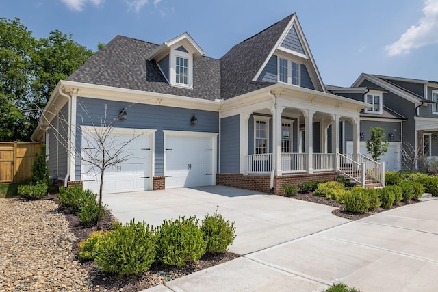 7085 Bolton St, Franklin, TN 37064 - view of front of property with covered porch, a garage, driveway, and roof with shingles