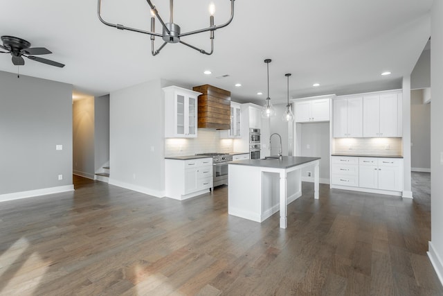 kitchen with white cabinetry, a kitchen island with sink, and stainless steel appliances