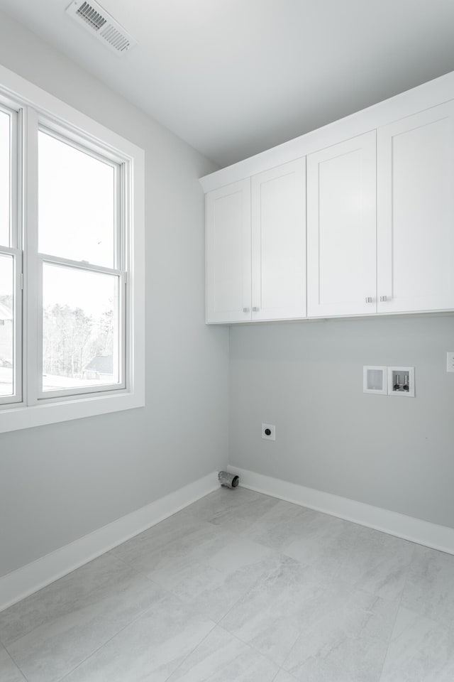 laundry room with cabinets, washer hookup, and electric dryer hookup