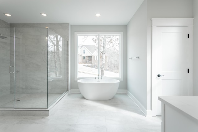 bathroom featuring vanity and plus walk in shower