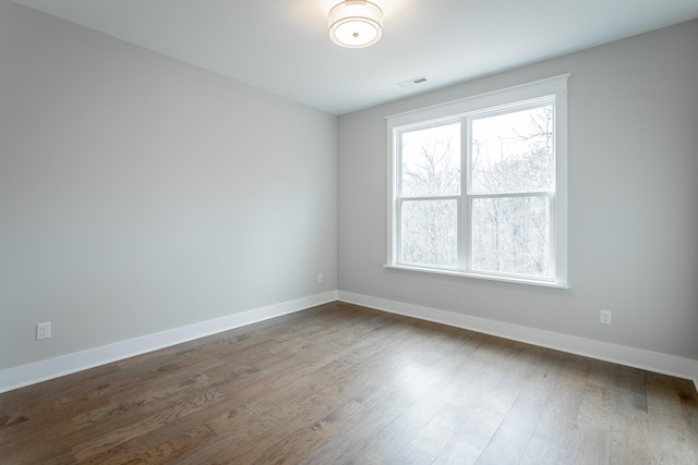 spare room featuring dark hardwood / wood-style floors