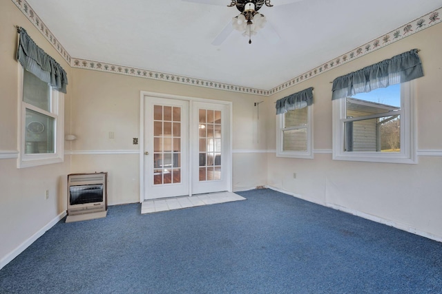 unfurnished room featuring french doors, carpet, ceiling fan, and heating unit