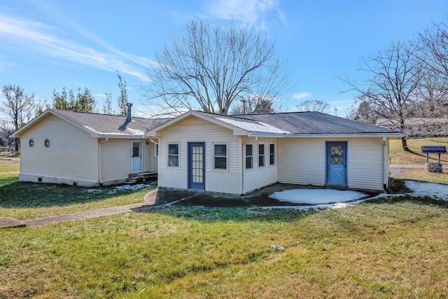 rear view of house with a lawn