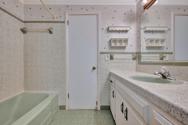 bathroom with tile walls, bathing tub / shower combination, and vanity