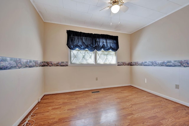 empty room with ceiling fan, ornamental molding, and light hardwood / wood-style floors