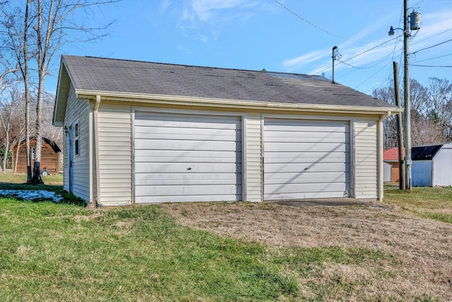 garage featuring a lawn