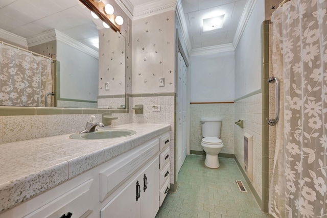 bathroom featuring toilet, vanity, tile walls, and ornamental molding