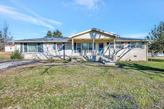 ranch-style home featuring covered porch and a front yard