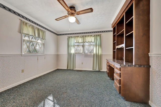 interior space with ceiling fan and dark carpet