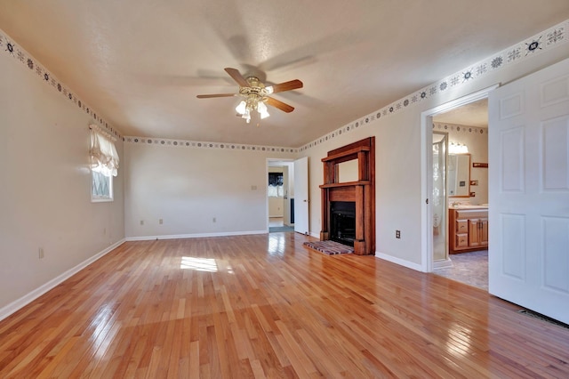 unfurnished living room with ceiling fan and hardwood / wood-style flooring