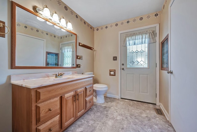 bathroom featuring toilet and vanity