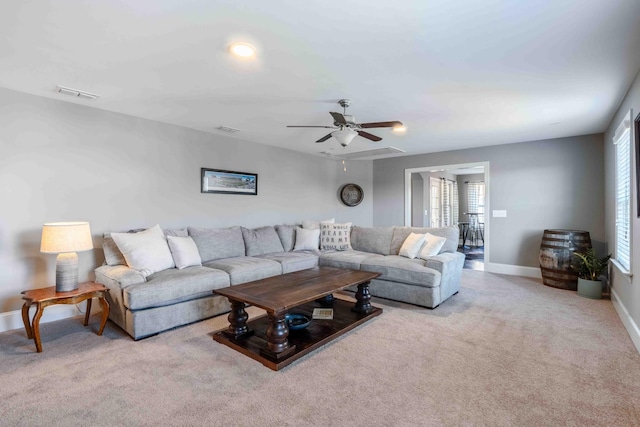 living room with light carpet and ceiling fan