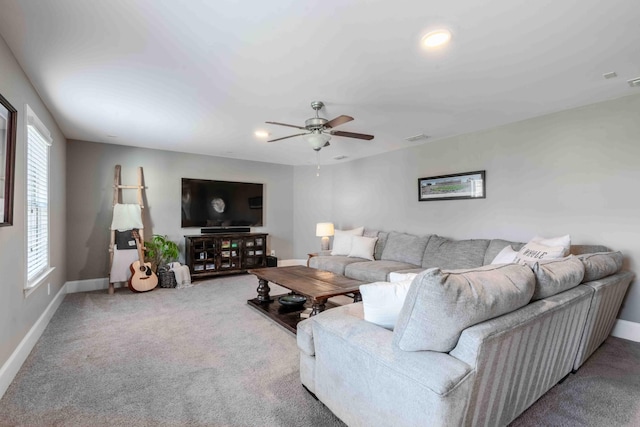 carpeted living room featuring ceiling fan