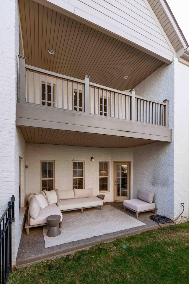 view of patio featuring an outdoor living space and a balcony