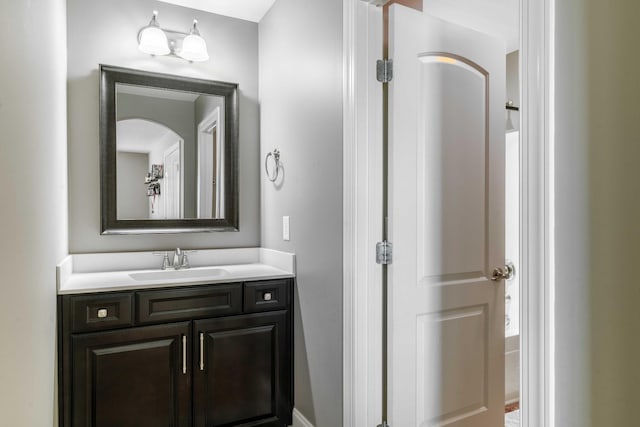 bathroom featuring vanity and a tub to relax in