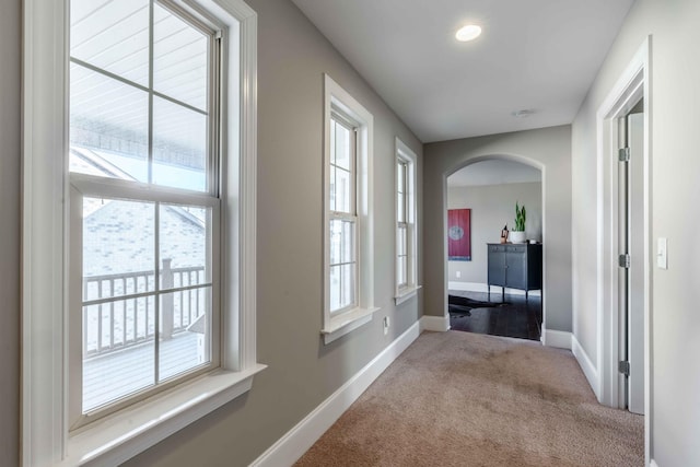 hallway featuring light colored carpet