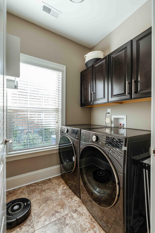 laundry room with cabinets and separate washer and dryer