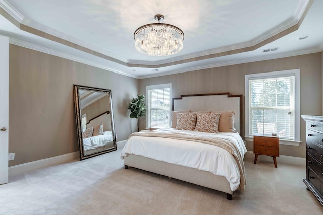 bedroom featuring a tray ceiling, light colored carpet, a chandelier, and ornamental molding