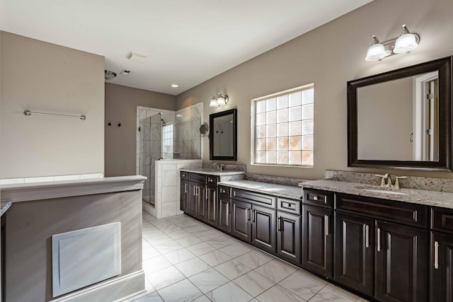 bathroom featuring a tile shower and vanity