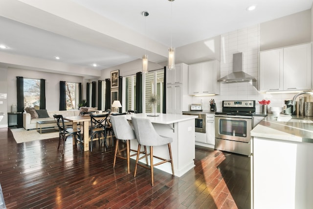 kitchen featuring white cabinetry, stainless steel electric range oven, dark wood-type flooring, and wall chimney range hood