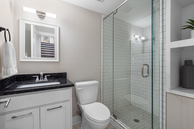 bathroom with vanity, toilet, and an enclosed shower