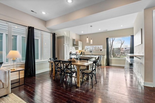 dining area with dark hardwood / wood-style flooring