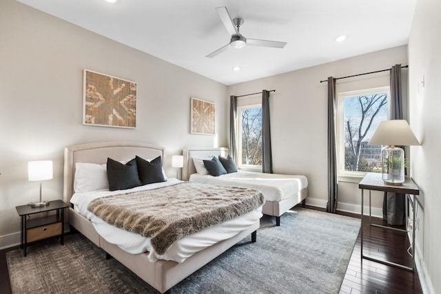 bedroom with ceiling fan and dark wood-type flooring