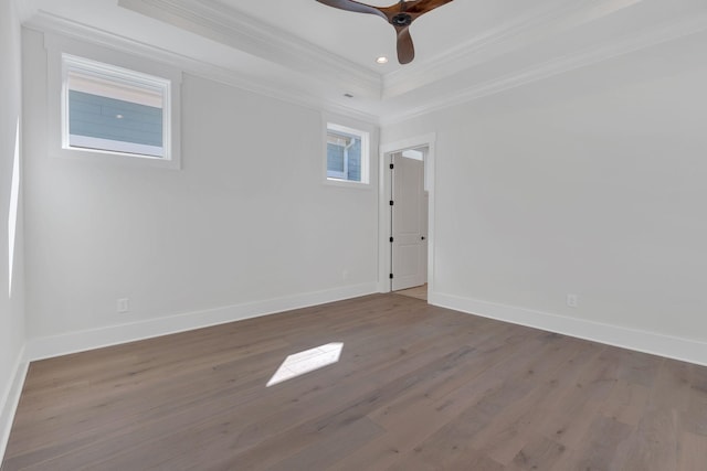 spare room featuring ornamental molding, wood finished floors, and baseboards