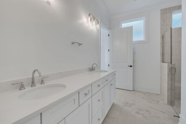 full bath featuring marble finish floor, ornamental molding, tiled shower, and a sink