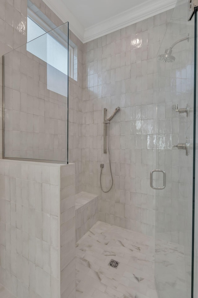 bathroom with a shower stall and crown molding