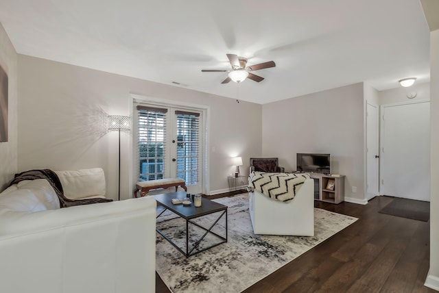 living room with ceiling fan, dark hardwood / wood-style flooring, and french doors